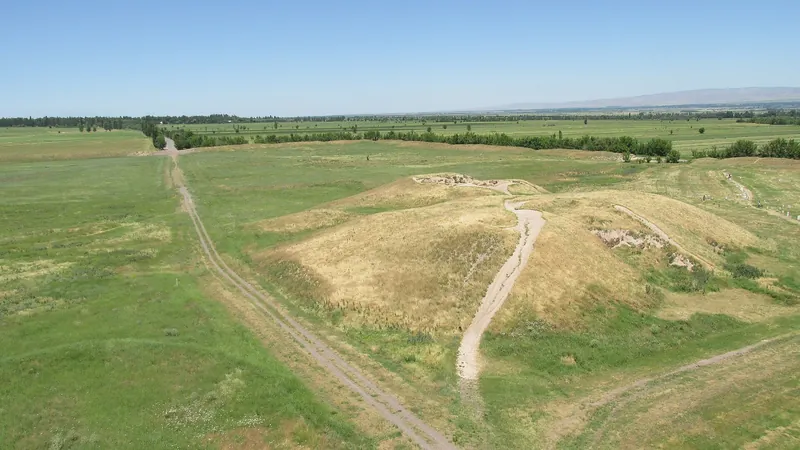 From above, the ancient town’s earth ramparts and paths can be seen among flat green fields.