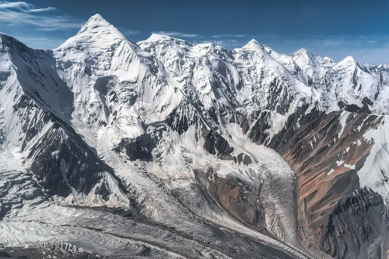 View from the helicopter of snowy peaks and the crevasses of South Engilchek Glacier in the Central Tian Shan