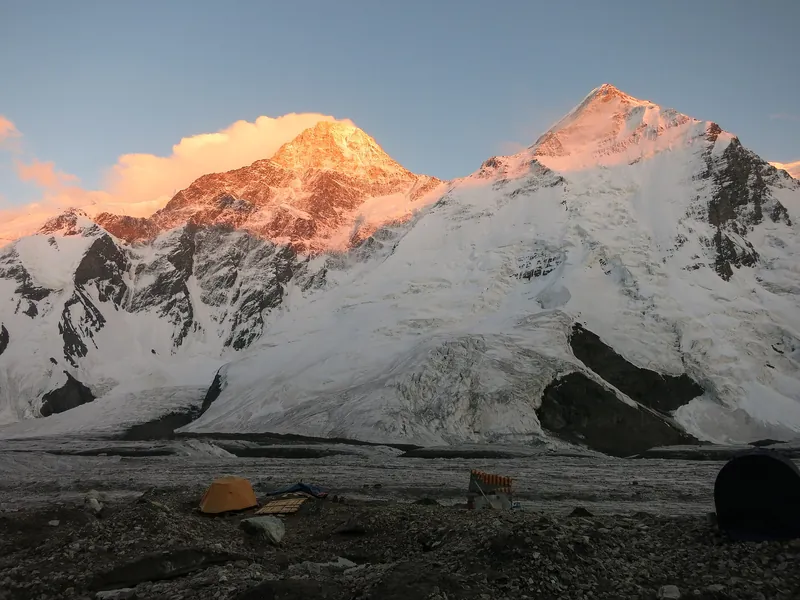 The sharp pyramid of Khan Tengri above a snowy cirque and a glacier tongue in clear weather